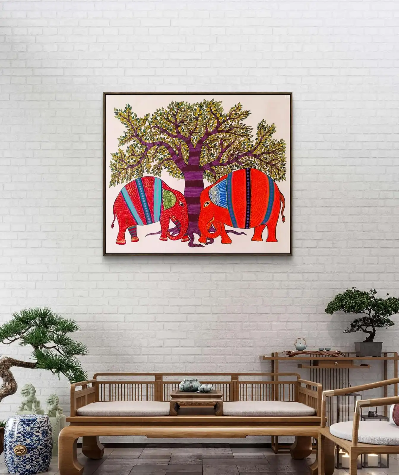 Framed Gond Elephant Harmony painting displayed on a wall showing colorful elephant artwork in Gond art style.